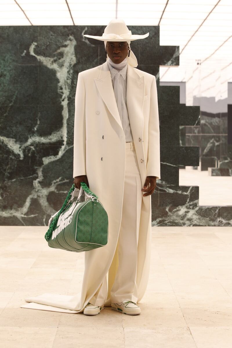 Wearing a durag, and a coat cut to trail on the floor, a model appears in the autumn/winter 2021 show, Louis Vuitton menswear, by Virgil Abloh. Photo: Louis Vuitton