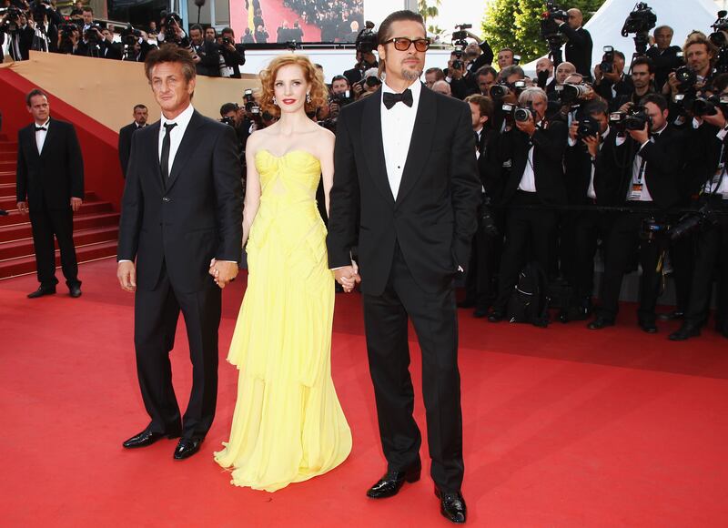 Jessica Chastain, in a yellow Zac Posen gown, with Sean Penn and Brad Pitt, attends 'The Tree Of Life' premiere during the 64th Annual Cannes Film Festival at Palais des Festivals on May 16, 2011. Getty Images