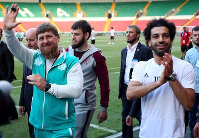 In this photo taken on Sunday, June 10, 2018, Egyptian national soccer team player and Liverpool's star striker Mohammed Salah, right, and Chechen regional leader Ramzan Kadyrov, greets soccer fans as they arrive to attend the Egypt national soccer team training session in Grozny, Russia. Egyptian national soccer team will compete in the 2018 World Cup in Russia. The 21st World Cup begins on Thursday, June 14, 2018, when host Russia takes on Saudi Arabia. (AP Photo)