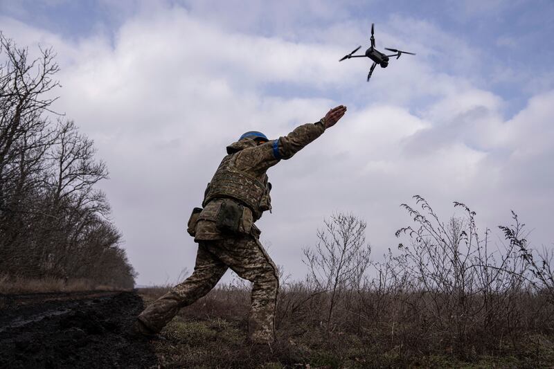 A Ukrainian soldier flies a drone at the front line near Vuhledar. AP