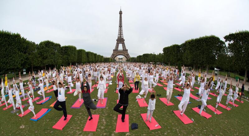 People gather for an open-air yoga session near the Eiffel tower in Paris. Philippe Wojazer / Reuters