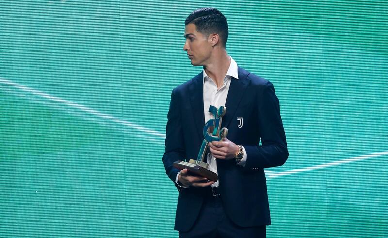 Cristiano Ronaldo stands with the trophy at the Gran Gala del Calcio 2019 ceremony. AP Photo