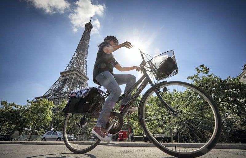 PARIS, FRANCE - AUGUST 04: A cyclist rides past the Eiffel Tower on August 04, 2020 in Paris, France. Since the end of lockdown the number of cyclists in Paris has risen by nearly 50 percent as authorities have encouraged cycling as a safer, and more environmentally friendly form of transport away from crowded buses and metro trains as they continue to try to halt the spread of COVID-19. Mayor Anne Hidalgo has added a further 31 miles of roadway in the city for bikes with the promise of making Paris a cycling capital.  (Photo by Kiran Ridley/Getty Images)