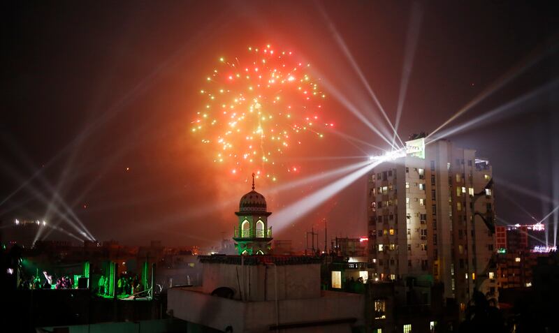 Fireworks and laser lights illuminate the sky during the Poush Sankranti celebration in Old Dhaka. EPA