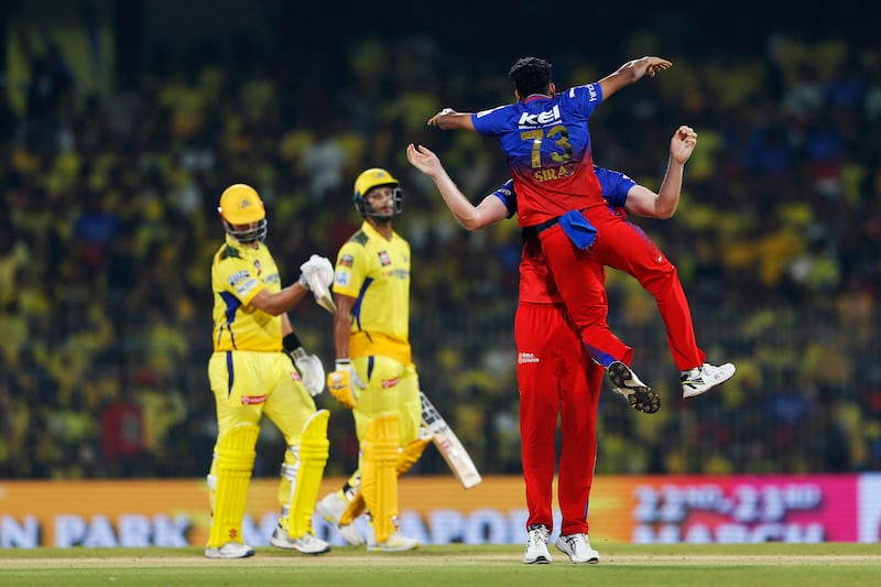 Royal Challengers Bengaluru's Mohammed Siraj jumps up as he congratulates teammate Cameron Green for taking the wicket of Chennai Super Kings' Daryl Mitchell. AP 