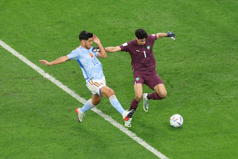 Morocco goalkeeper Bono is put under pressure by Marco Asensio of Spain. Getty 