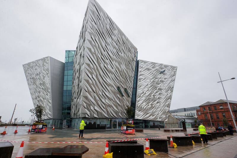 Staff outside the Titanic Belfast visitor attraction which has temporarily shut due to damage to its roof, in Northern Ireland. PA