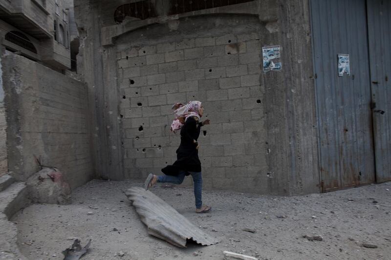 Sixty of those victims died in the neighbourhood of Shejaiya which lies between Gaza City and the border. Seen here is a Palestinian woman running for cover in the Shujaieh neighbourhood which has seen heavy shelling.