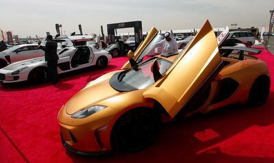 Dubai, United Arab Emirates- February, 28, 2013; Visitors browse the  Luxury Cars  displayed during the  Auto Trader Luxury Car show in Dubai  . (  Satish Kumar / The National ) For Business
