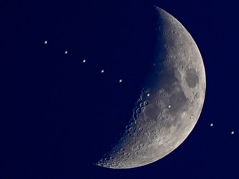 A multiple exposure photograph shows the International Space Station with the Moon in the background above Liverpool on Monday. PA