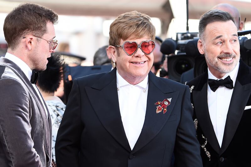 Elton John, in a black suit with a rocket detailing and heart-shaped sunglasses, attends the screening of 'Rocketman' during the 72nd Annual Cannes Film Festival on May 16, 2019. Getty Images