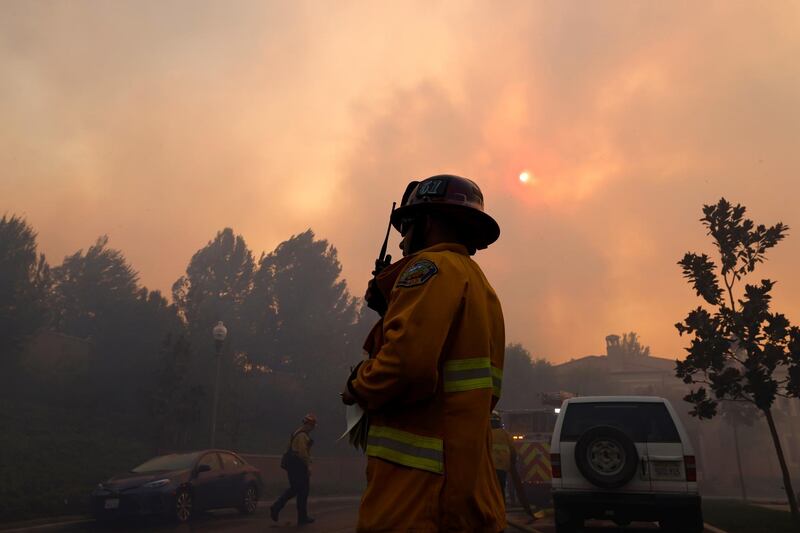 Firefighters gather as the Silverado Fire approaches, near Irvine, California, US October 26, 2020. REUTERS