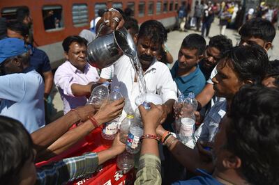 Drinking water is dished out to train passengers in Jalandhar. AFP