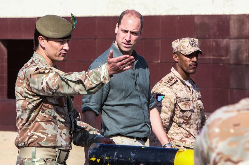 Prince William (C), Duke of Cambridge, listens as he attends the Exercise Desert Warrior between British and Kuwaiti forces at Sheikh Salem al-Ali al-Sabah Camp, about 40 kilometres north of Kuwait City. AFP