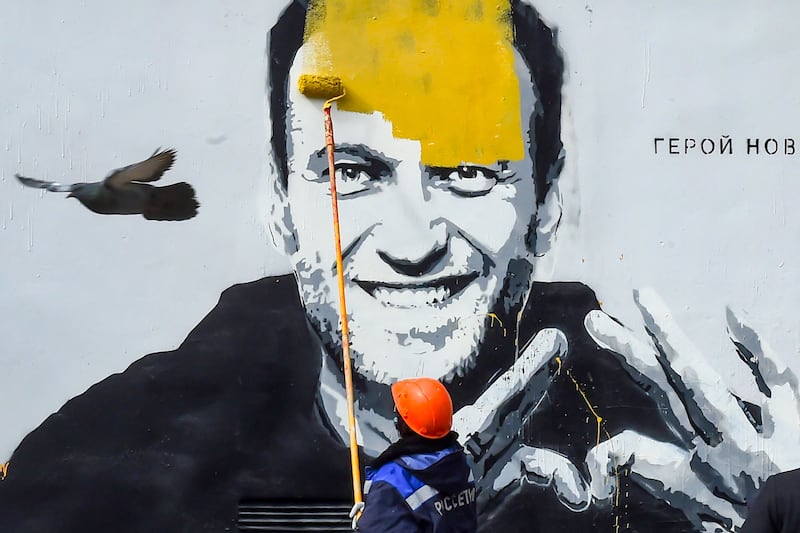A 2021 mural of Mr Navalny in Saint Petersburg is painted over. AFP
