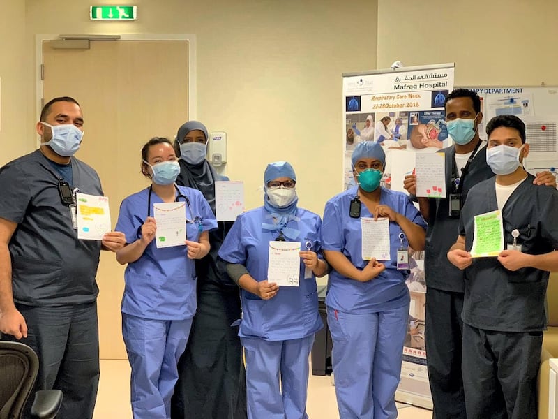 Abu Dhabi medical professionals hold up letters of appreciation they have received. Courtesy Seha