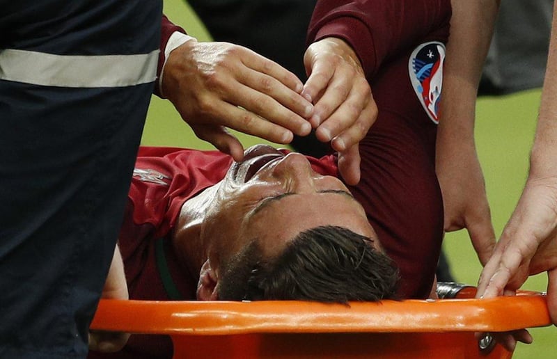 Portugal’s Cristiano Ronaldo is stretchered off injured during the Uefa Euro 2016 Final at the Stade de France, 10 July 2016. John Sibley / Reuters