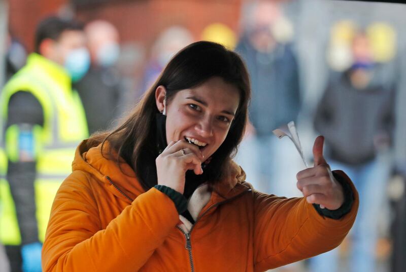 A woman gestures as she takes her own Covid-19 swab test in West Ealing, London. AP Photo