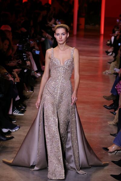 A model presents a shimmering creation by Elie Saab in Paris. AFP
