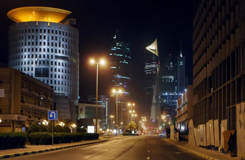 A photo taken on March 22, 2020 shows a deserted street in Kuwait city amid the COVID-19 coronavirus pandemic. Kuwait imposed a curfew nationwide starting on Sunday at 5pm until 4am to fight the spread of the coronavirus, state news agency KUNA said. / AFP / YASSER AL-ZAYYAT
