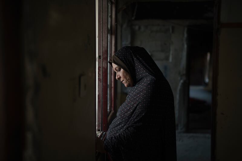 Palestinian Jawaher Nassir stands inside her home, in Beit Hanoun, northern Gaza Strip, heavily damaged by air strikes during the 11-day war between Hamas and Israel in May. AP