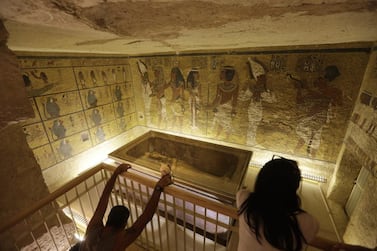 A file photo of tourists looking at the tomb of King Tut as it is displayed in a glass case at the Valley of the Kings in Luxor. Egypt's antiquities minister Mamdouh El Damaty, said on March 17, 2016, that analysis of scans of the famed king's burial chamber has revealed two hidden rooms that could contain metal or organic material. Amr Nabil/AP Photo