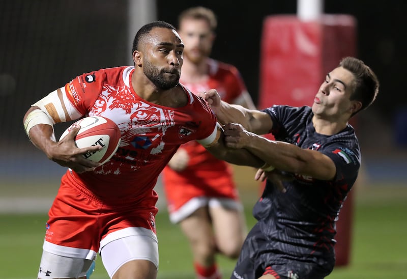 Dubai Tigers' Sakiusa Naisau carries the ball.