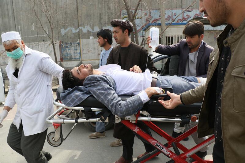 An injured man is brought on a stretcher to an ambulance following a gun attack during an event to mark the 25th anniversary of death of Shiite leader Abdul Ali Mazari, In Kabul.  AFP