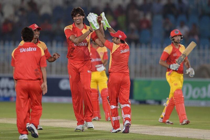 Islamabad United bowler Mohammad Irfan, centre, celebrates after taking a wicket. Aamir Qureshi / AFP
