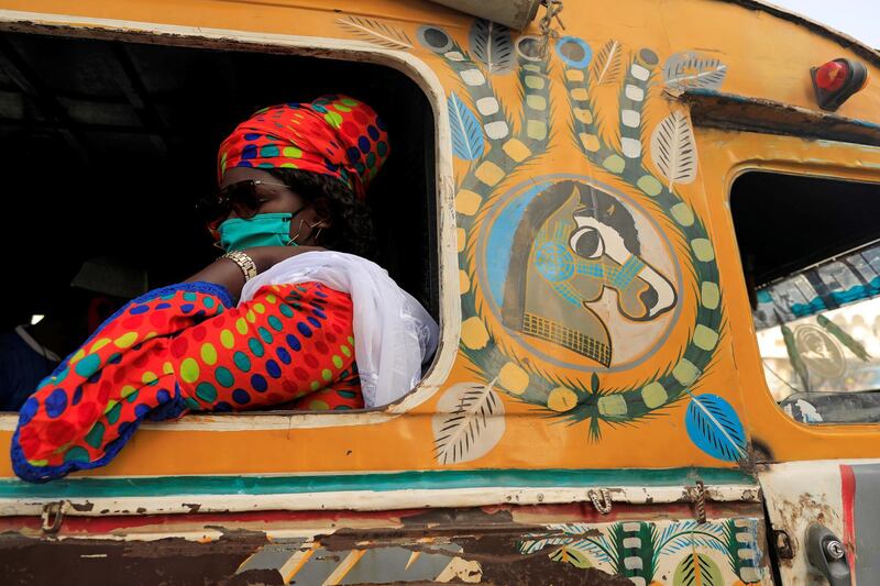 A passenger wearing a face mask sits on bus called "Car Rapide", amid the outbreak of the coronavirus disease in Dakar, Senegal. Reuters