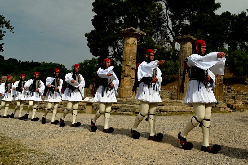 The Greek Guard of Honour, Evzones, passes by the Temple of Hera during the flame lighting ceremony. Getty Images