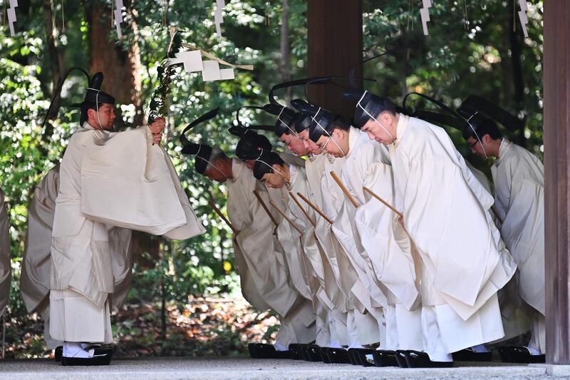 Shinto priests recite religious words before entering the main building to conduct a festive ceremony to report the enthronement of the new emperor to the royal family's ancestors at Meiji Shrine in Tokyo.. Japan's new Emperor Naruhito formally ascended the Chrysanthemum Throne, a day after his father abdicated from the world's oldest monarchy and ushered in a new imperial era.