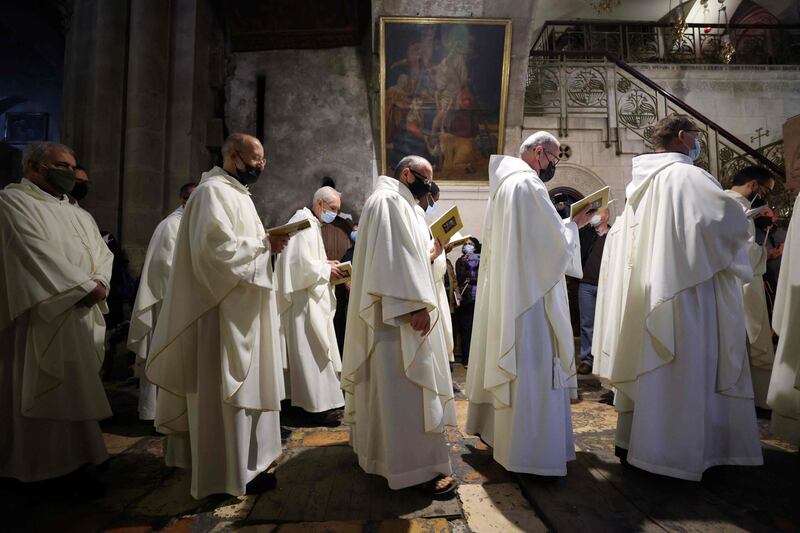 Held in the hours of darkness between sunset on Holy Saturday and sunrise on Sunday, the vigil mass is the first celebration of Easter. AFP