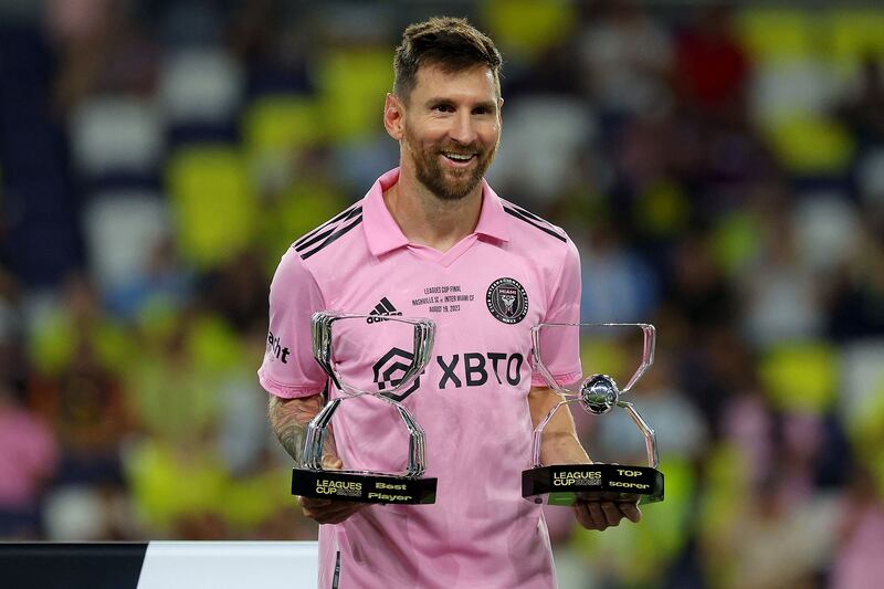 Lionel Messi poses with his Best Player Award and Top Scorer Award after the Leagues Cup final. AFP