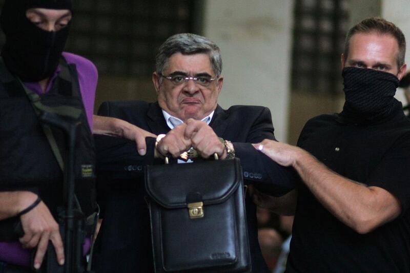 Leader of the extreme far-right Golden Dawn party Nikos Michaloliakos is escorted by anti-terror police in Athens. Eosphotos/Angeliki Panagiotou