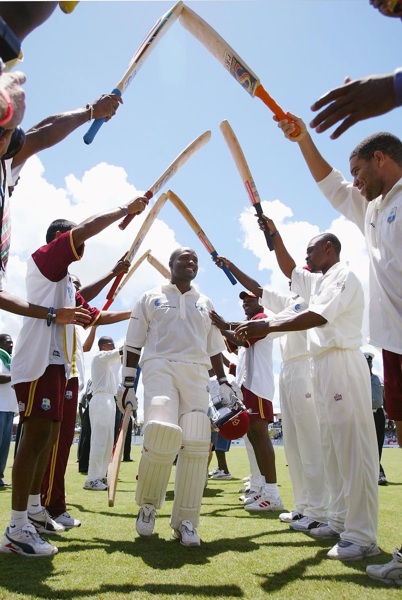ST JOHNS, ANTIGUA - APRIL 12:  Brian Lara is given a guard of honour as he leaves the field for lunch during day three of the fourth Test match between the West Indies and England at the Recreation Ground on April 12, 2004 in St Johns, Antigua. (Photo by Clive Rose/Getty Images).