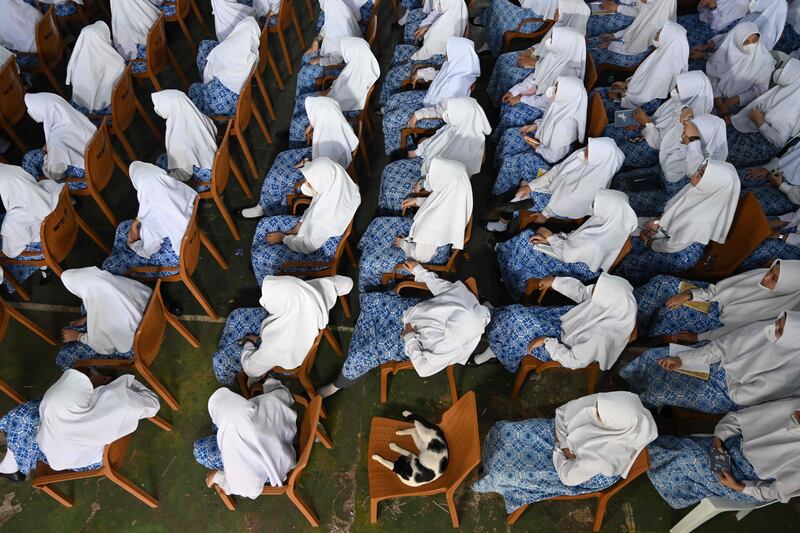 Indonesian students in Jakarta attend a ceremony during a visit by the Nottinghamshire Band of the Royal Engineers to celebrate British Queen Elizabeth II's platinum jubilee.  AFP