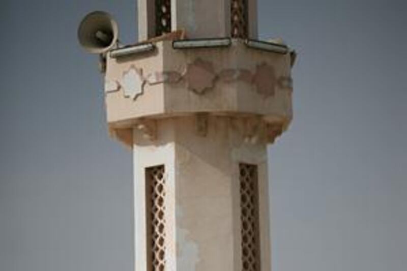 Paint is peeling off the minaret of the main mosque in the village of Alhala near Fujiarah.