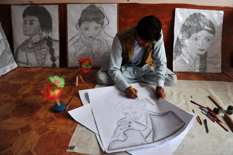 Afghan artist Maroof, 23, draws a picture of outgoing Afghan President Hamid Karzai to be sold in his shop in Jalalabad on April 24. Afghanistan's third presidential election brings an end to 13 years of rule by Karzai, who has held power since the Taliban were removed in a US-led invasion in 2001, and will be the first democratic handover of power in the country's turbulent history. Noorullah Shirzada / AFP Photo
