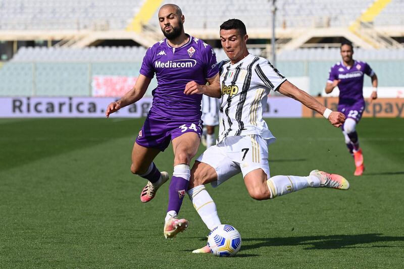 Juventus' Cristiano Ronaldo under pressure from Fiorentina's Sofyan Amrabat. AFP