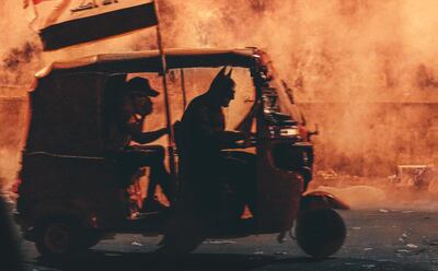 Batman drives a protester to safety in a tuktuk, a vehicle that has become symbolic in the Iraqi protests. Courtesy Ahmad Shwqy