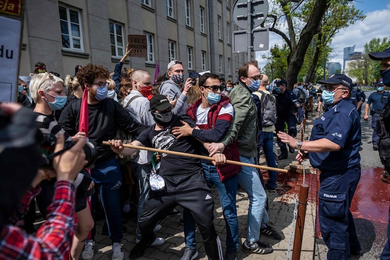 Police and participants of a protest in solidarity with the Palestinians talk outside the Israeli embassy in Warsaw, Poland. AFP