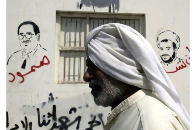 Graffiti in the Shiite village of Malkiya depicts jailed Bahraini opposition figures Ibrahim Sharif, left, and Mohammed Habib Al Muqdad. Hasan Jamali / AP Photo