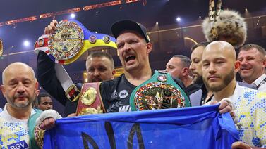 Oleksandr Usyk celebrates his victory over Tyson Fury with his team and all the heavyweight world title belts. AFP