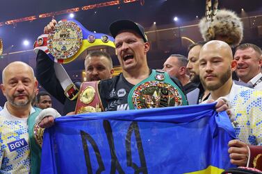 Oleksandr Usyk celebrates his victory over Tyson Fury with his team and all the heavyweight world title belts. AFP