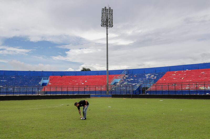 An Arema FC player he pays condolence on the pitch to victims of the soccer match riot and stampede at Kanjuruhan Stadium in Malang, East Java, Indonesia, on October 3. EPA