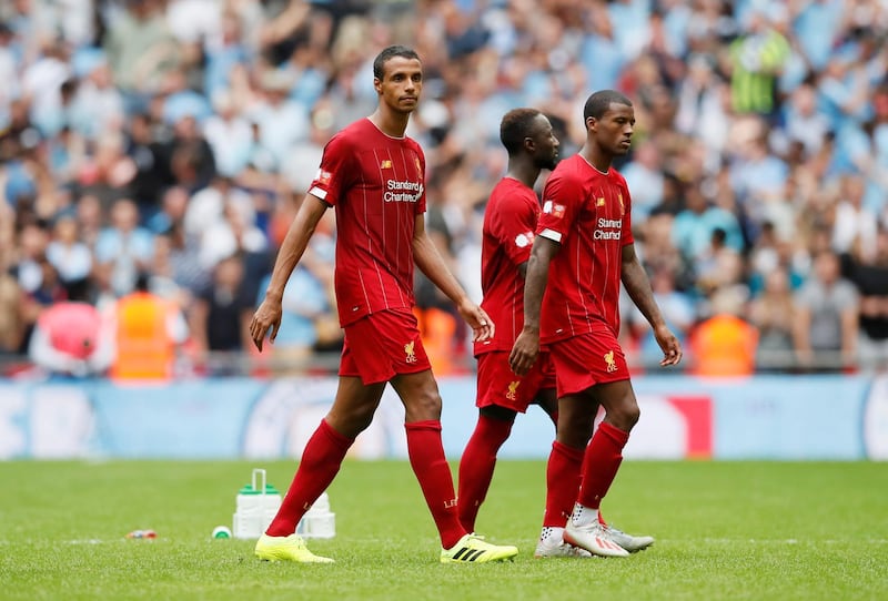 Liverpool's Joel Matip looks dejected with Wijnaldum and teammates. Reuters