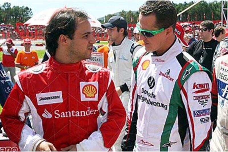 Michael Schumarcher, right, talks with the Ferrari driver Felipe Massa at a  karting charity event in  in Florianopolis, Brazil, last month.