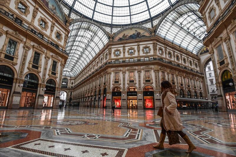 A general view shows a woman walk across the deserted Vittorio Emanuele II galleria shopping mall in Milan, Italy.  AFP