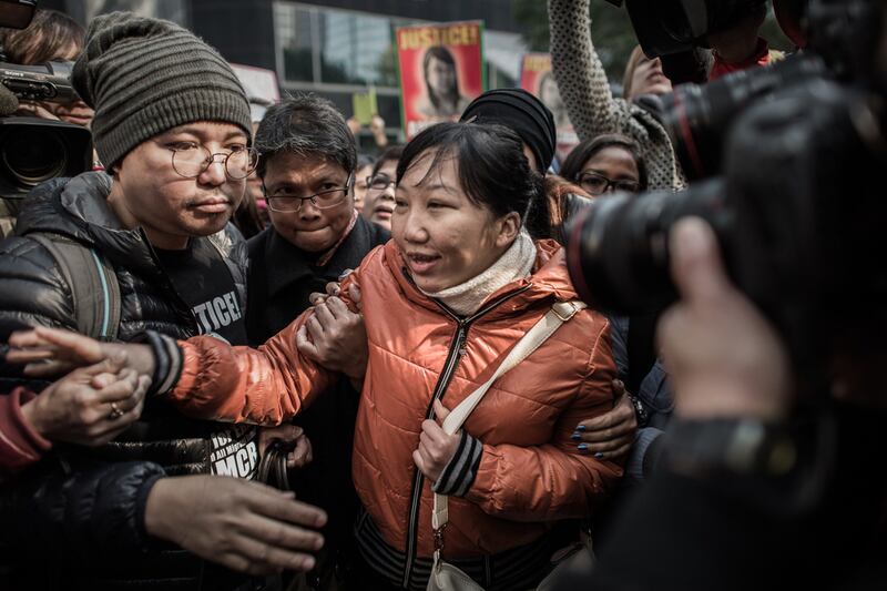 Former Indonesian maid Erwiana Sulistyaningsih, centre, arriving at the court of justice in Hong Kong on February 10, 2015. Her former employer was convicted of mistreating her in a case that sparked international outrage. Philippe Lopez/AFP Photo

